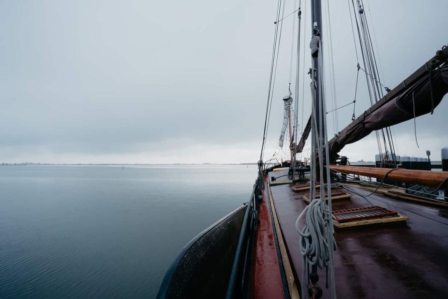 Looking forward along the deck of De Chateauroux over calm grey open water