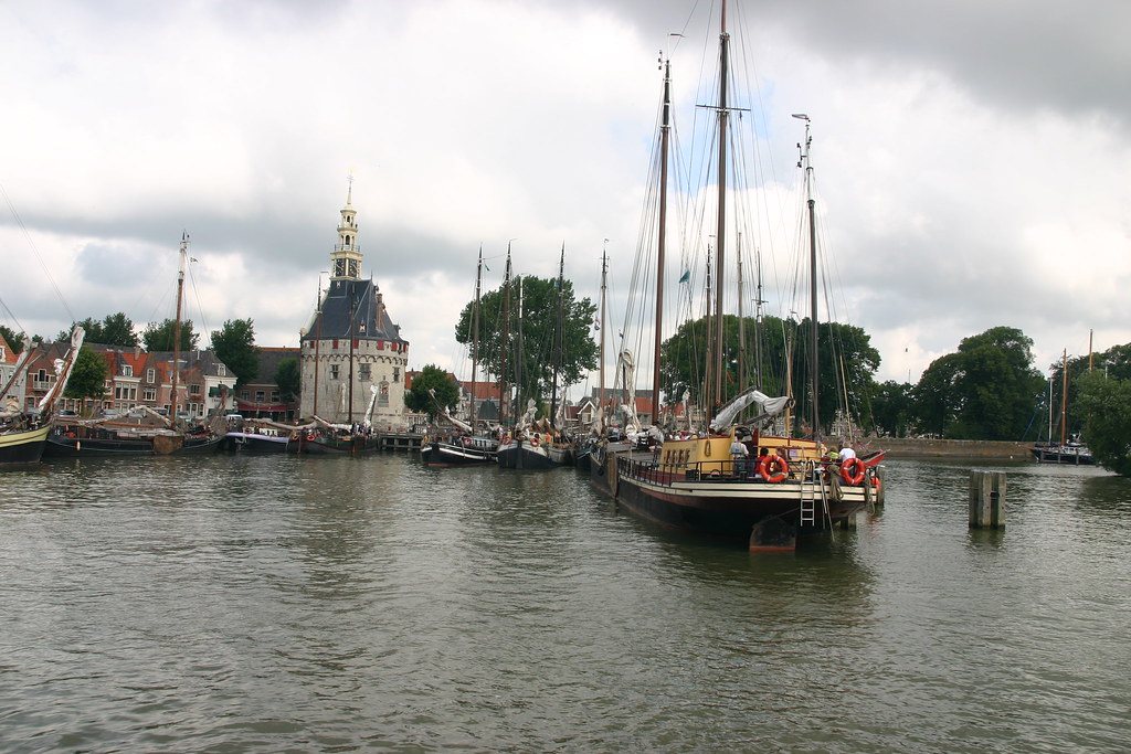De Chateauroux moored beneath the old harbour tower of Hoorn among other traditional sailing ships