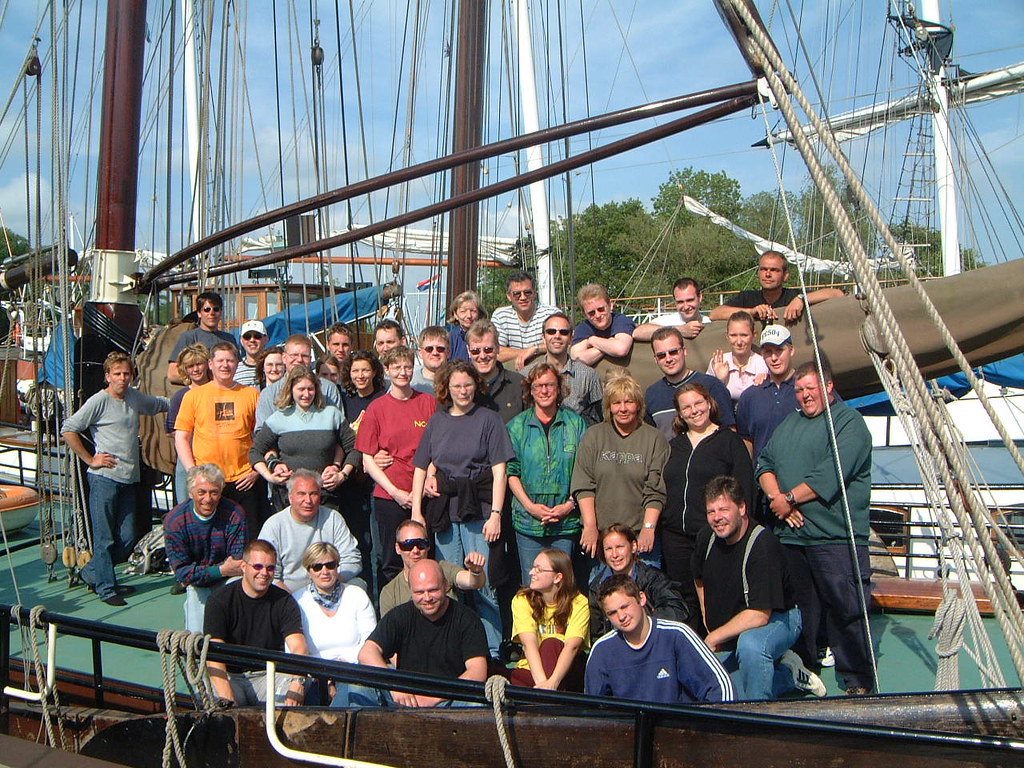 A large group of guests posing together on the foredeck