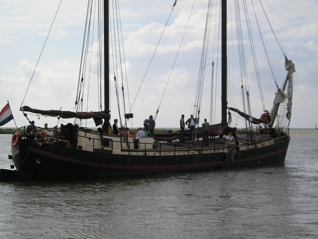 De Chateauroux in silhouette under sail against a pale evening sky